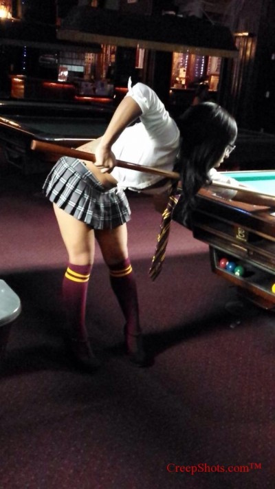 school girl playing pool